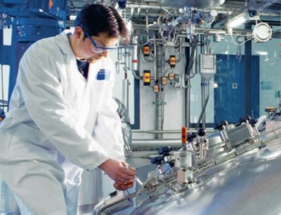 Ein Bilfinger-Mitarbeiter verrichtet Arbeiten an einem Bioreaktor