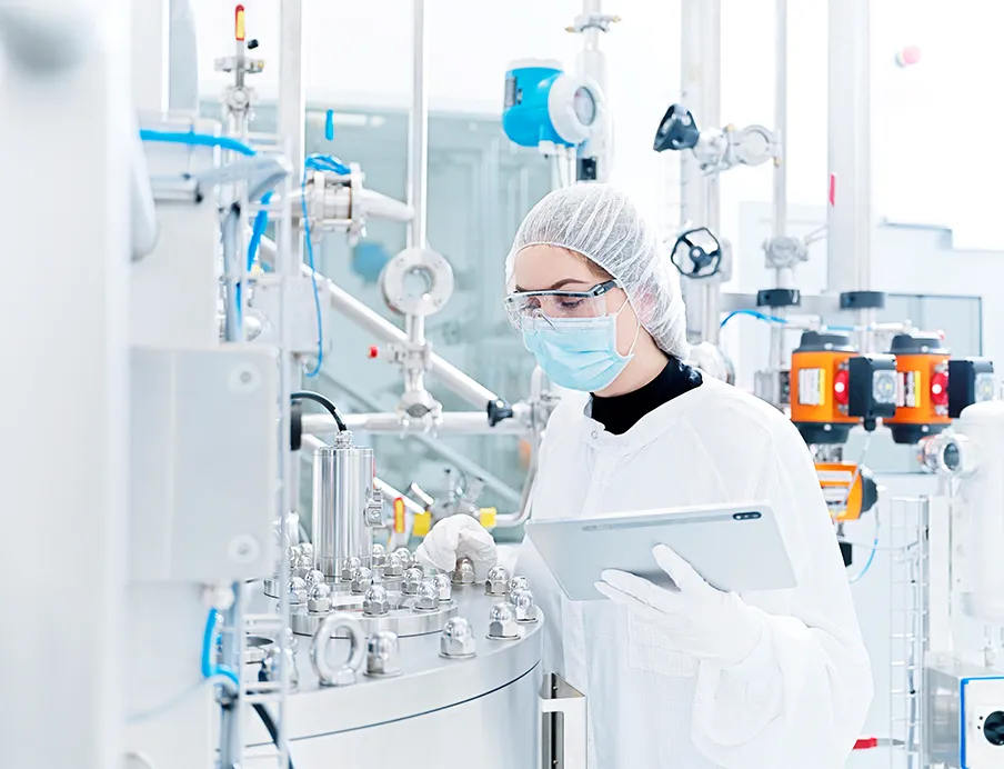 Spiegltec Mitarbeiterin an einer Pharma-Industrieanlage 